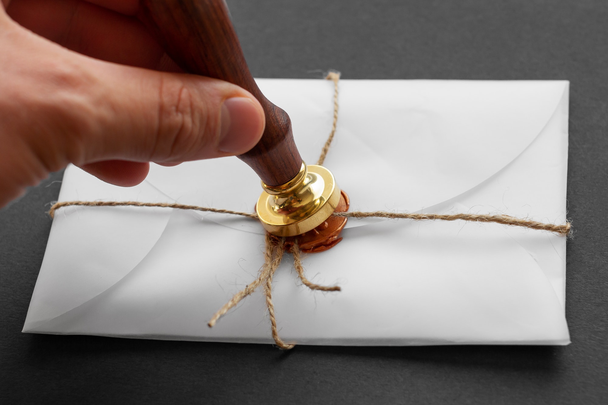 Notary public wax stamper. White envelope with brown wax seal, golden stamp. Responsive design